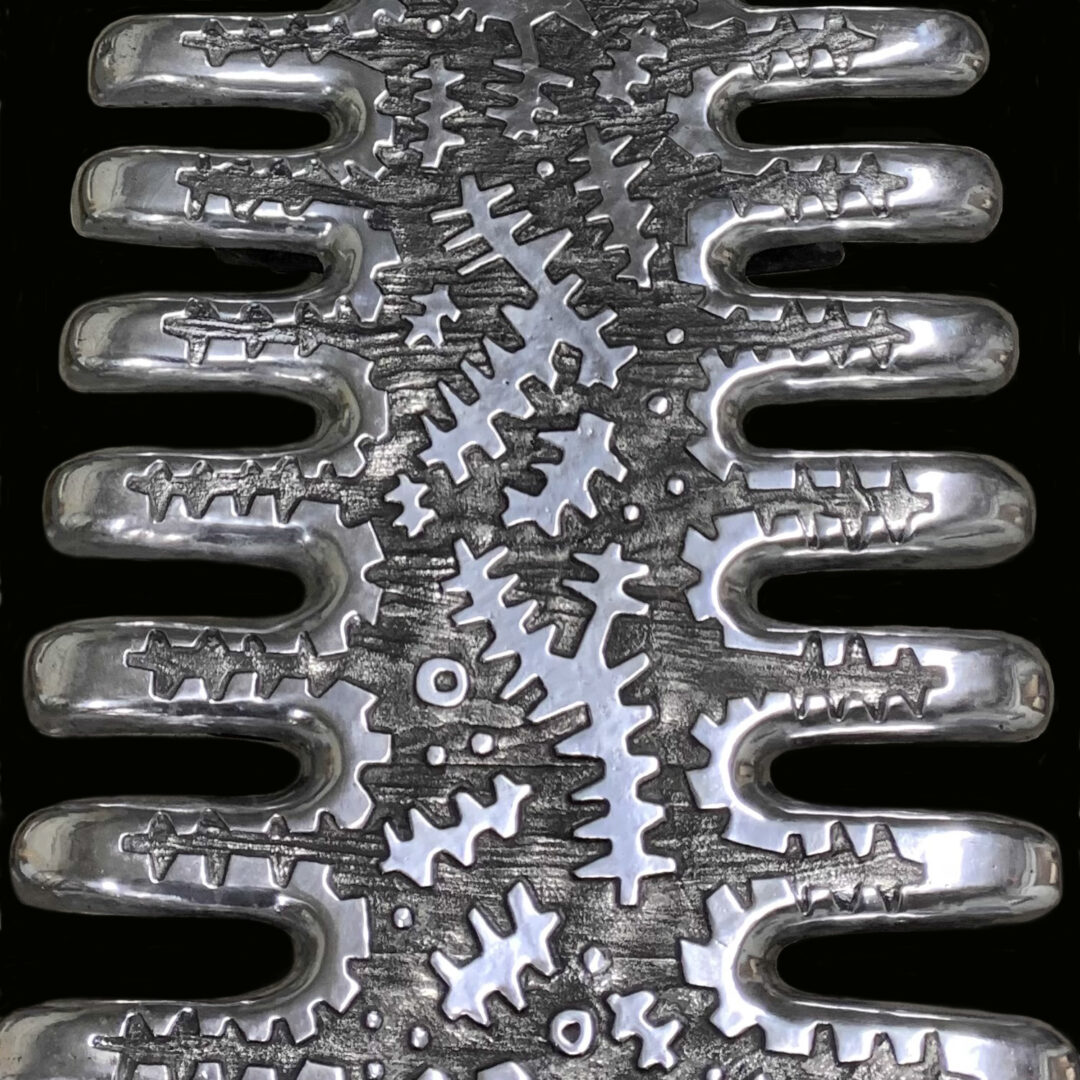 A metal object with many gears on it.