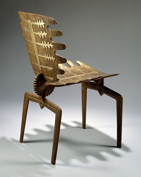 A chair made out of wooden sticks and nails.