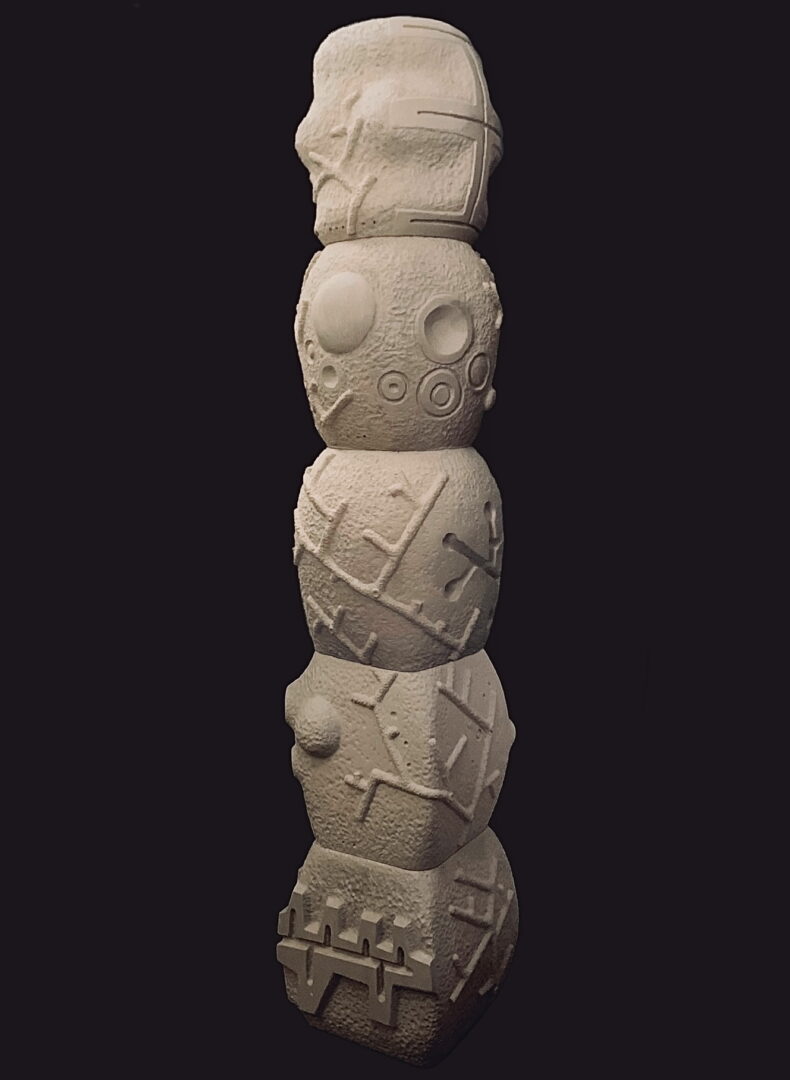 A tall white sculpture of skulls and crosses.
