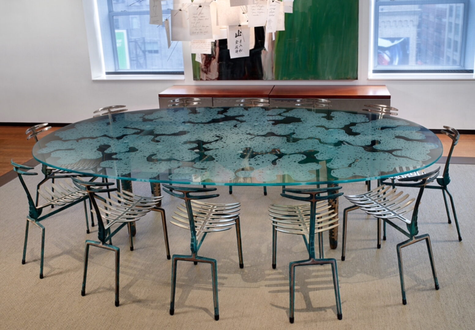 A large round glass table with chairs around it