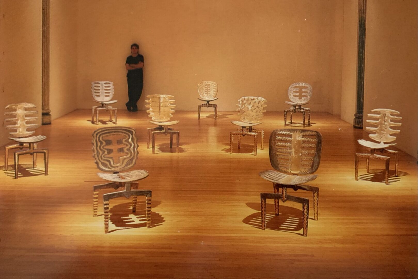 A person standing in front of many chairs on the floor.