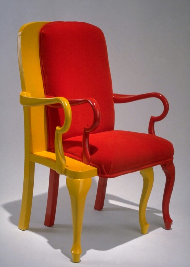 A red and yellow chair sitting on top of each other.