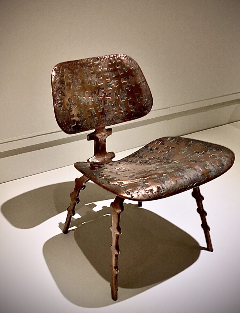 A chair with metal legs and a wooden seat.
