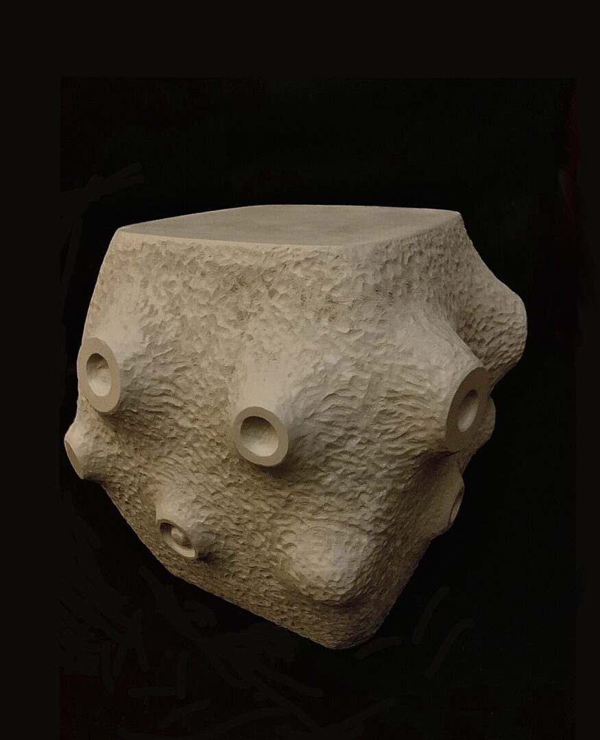 A stone sculpture of a face with eyes and mouth.