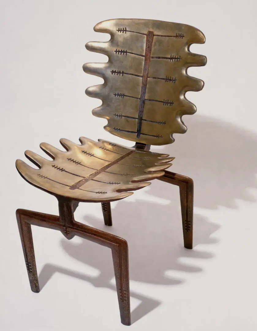 A chair made of brass and wood.