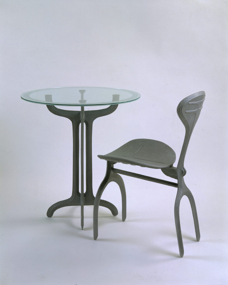 A table and chair set with glass top.